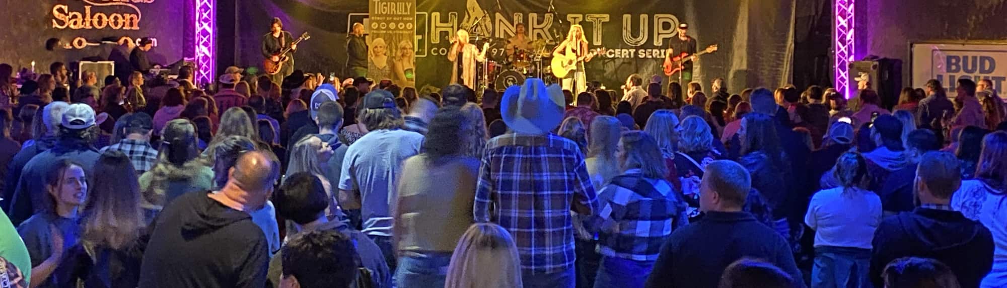 country concert with fans wearing cowboy hats Little Rock